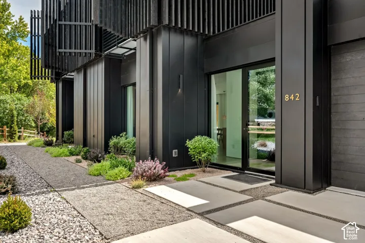 Modern exterior featuring dark vertical siding and slatted architectural details