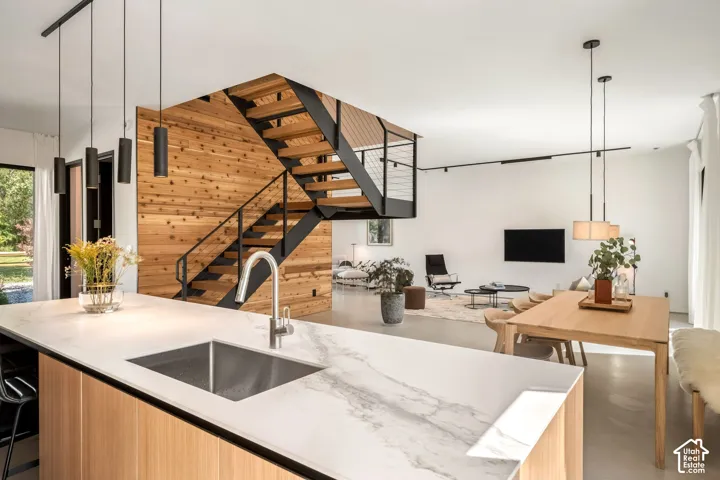 Open-concept living space with a wood-clad accent wall