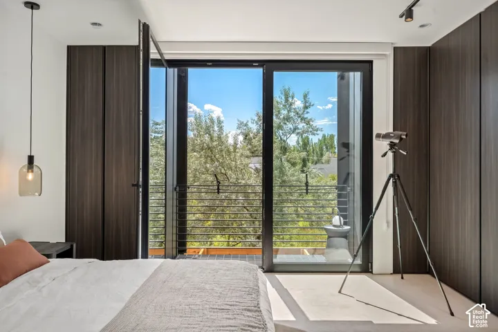 Sliding glass door opening to a private balcony with horizontal metal railings