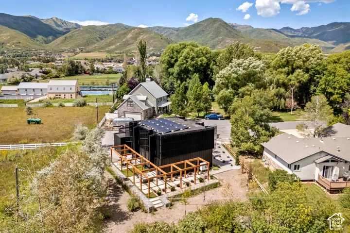 Modern dwelling with a dark-toned exterior and rooftop solar panels