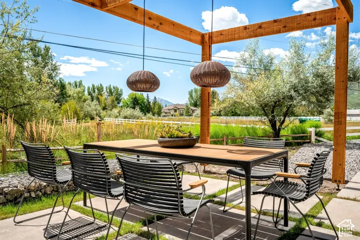 Outdoor patio featuring a wood pergola and concrete pavers