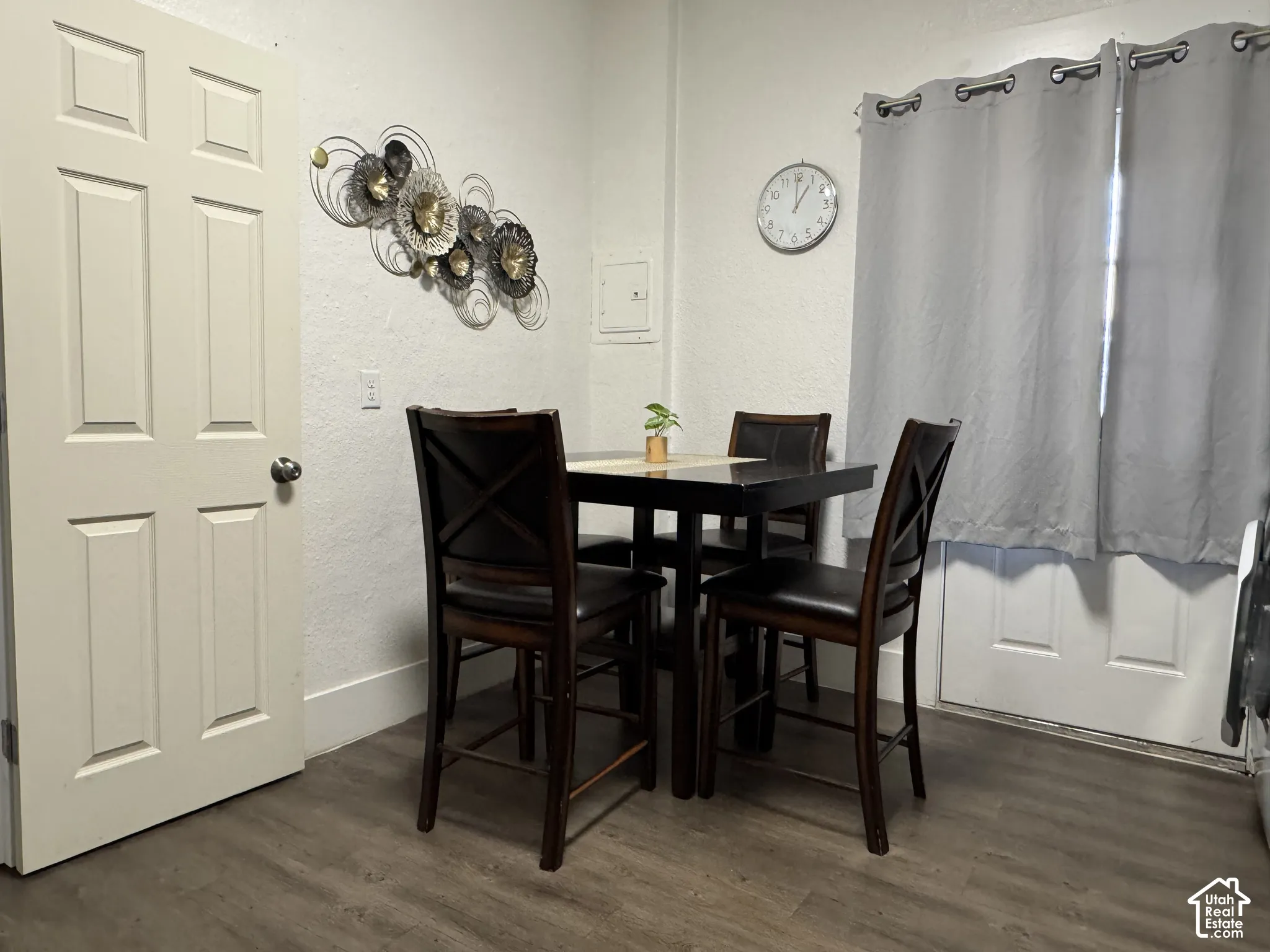 Wood-finish flooring with white baseboards