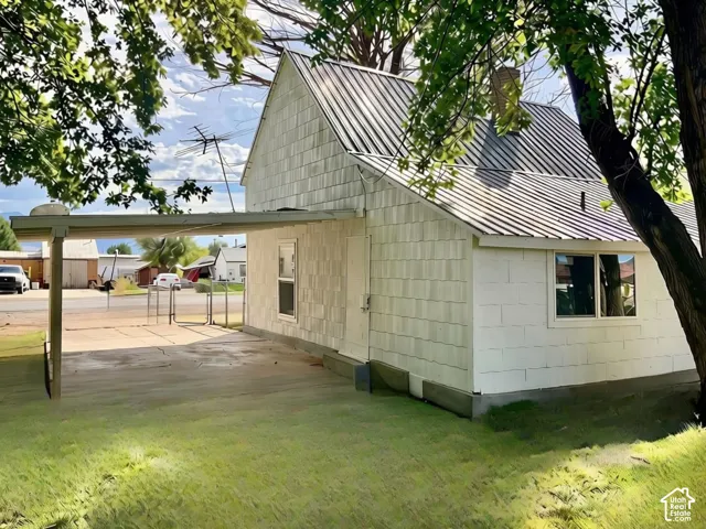 Exterior with horizontal siding and a metal roof