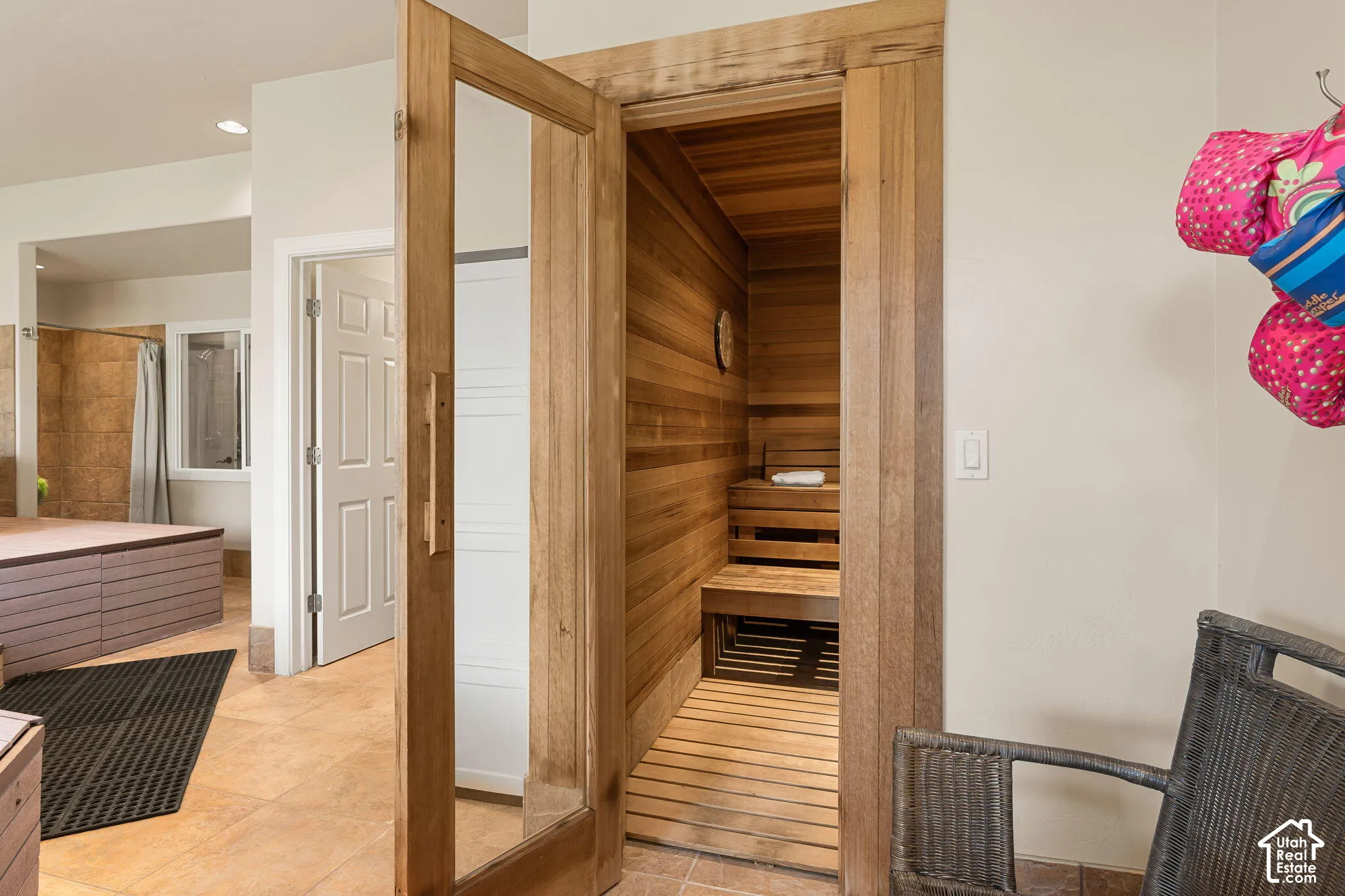 Cedar-paneled sauna with built-in wooden benches and slatted flooring