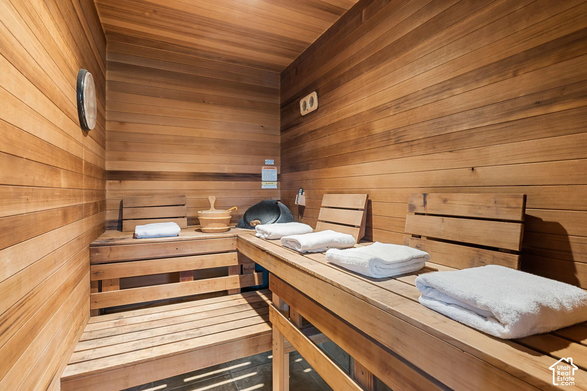 Wood-paneled interior featuring built-in wooden benches and slatted wood backrests