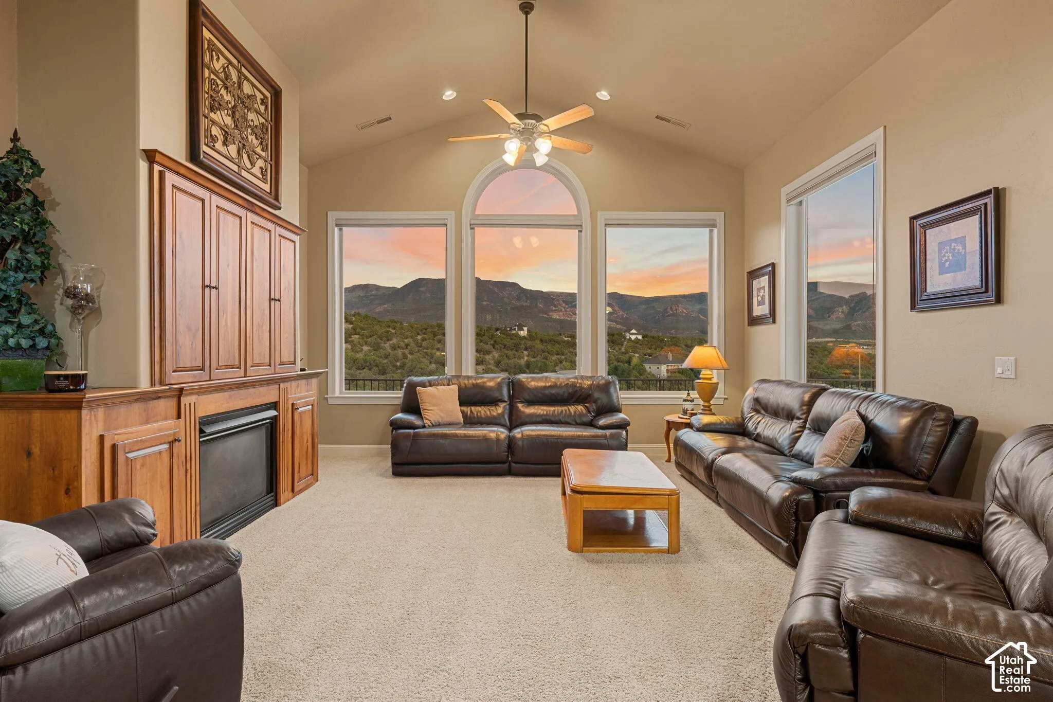 Vaulted ceiling with a ceiling fan, recessed lighting, and large picture windows