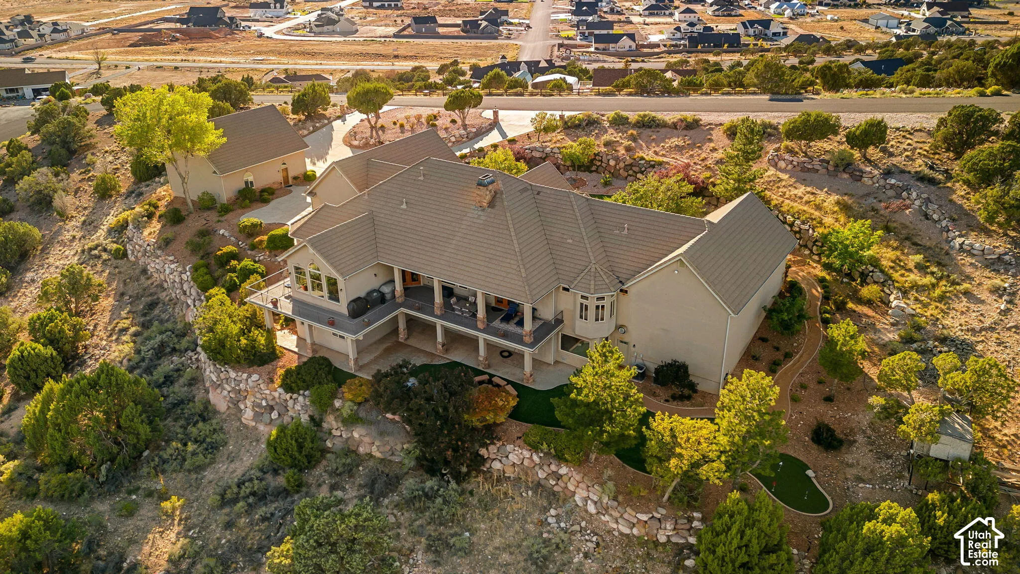 Two-story residence with a covered patio, multiple gables, and a detached structure