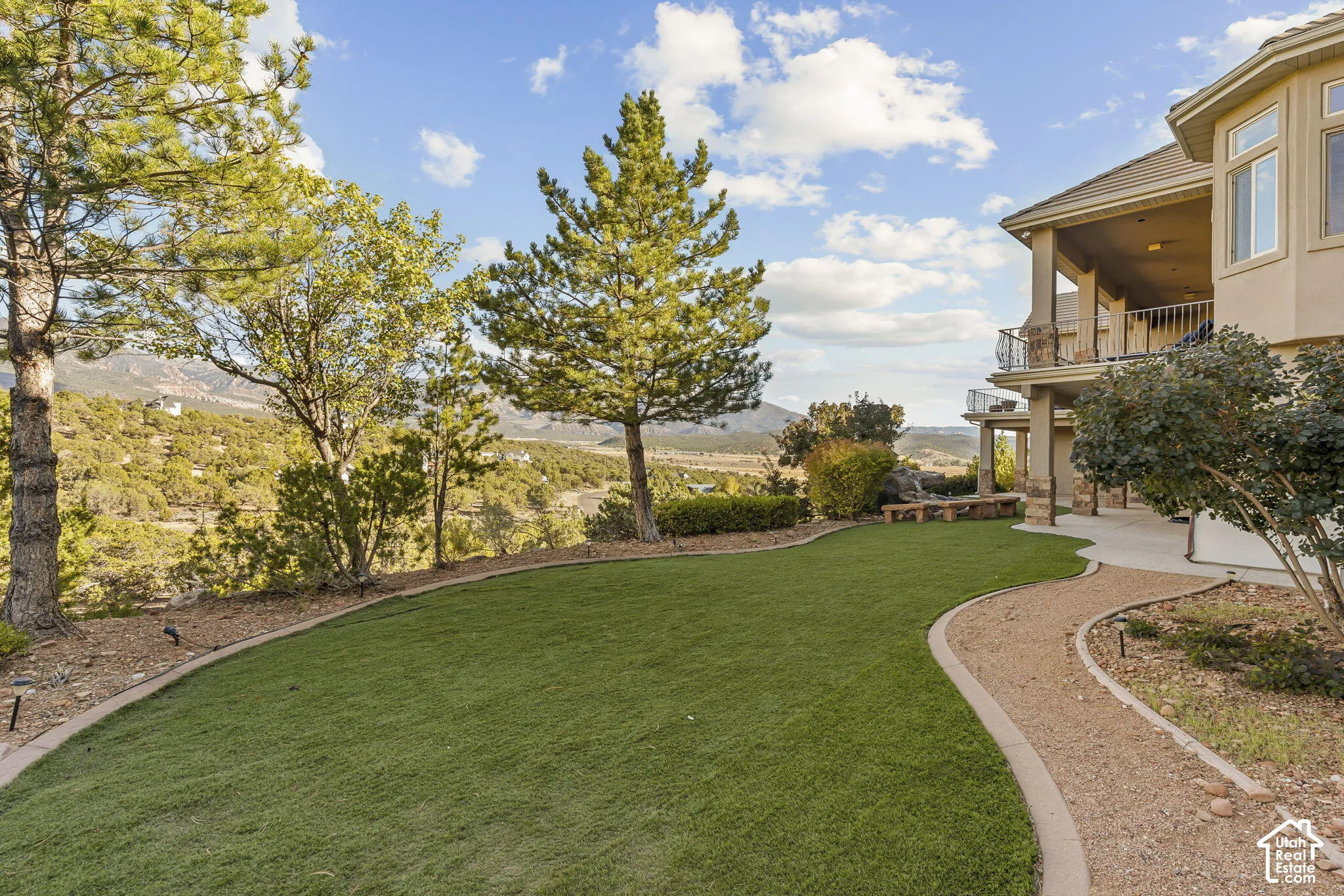 Terraced landscape with a broad green lawn and a winding gravel path