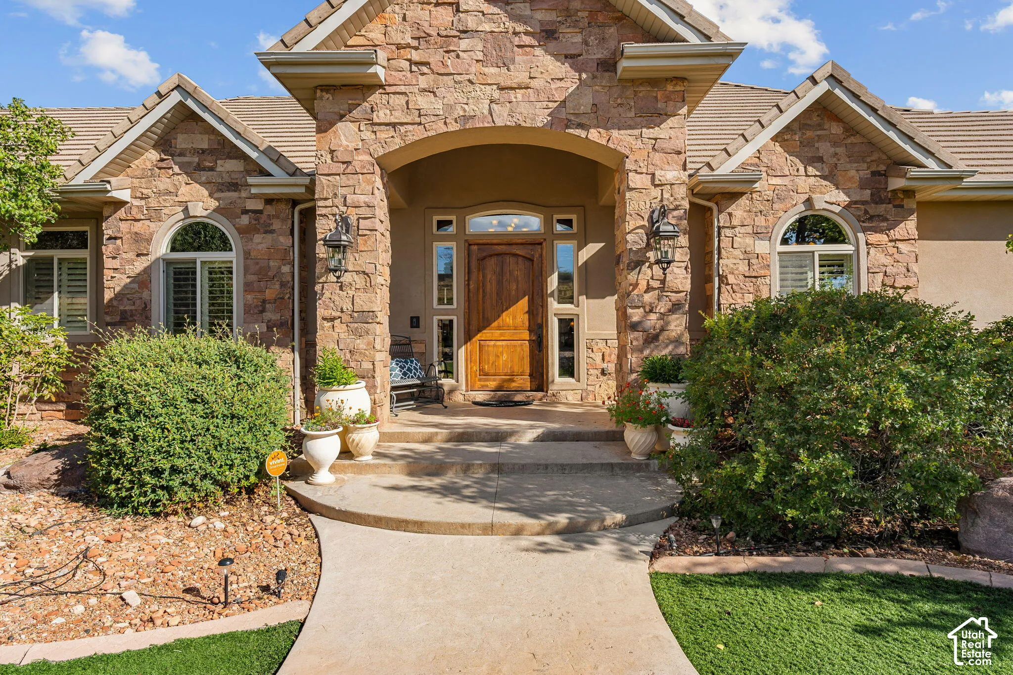 Stone veneer facade with arched entryway