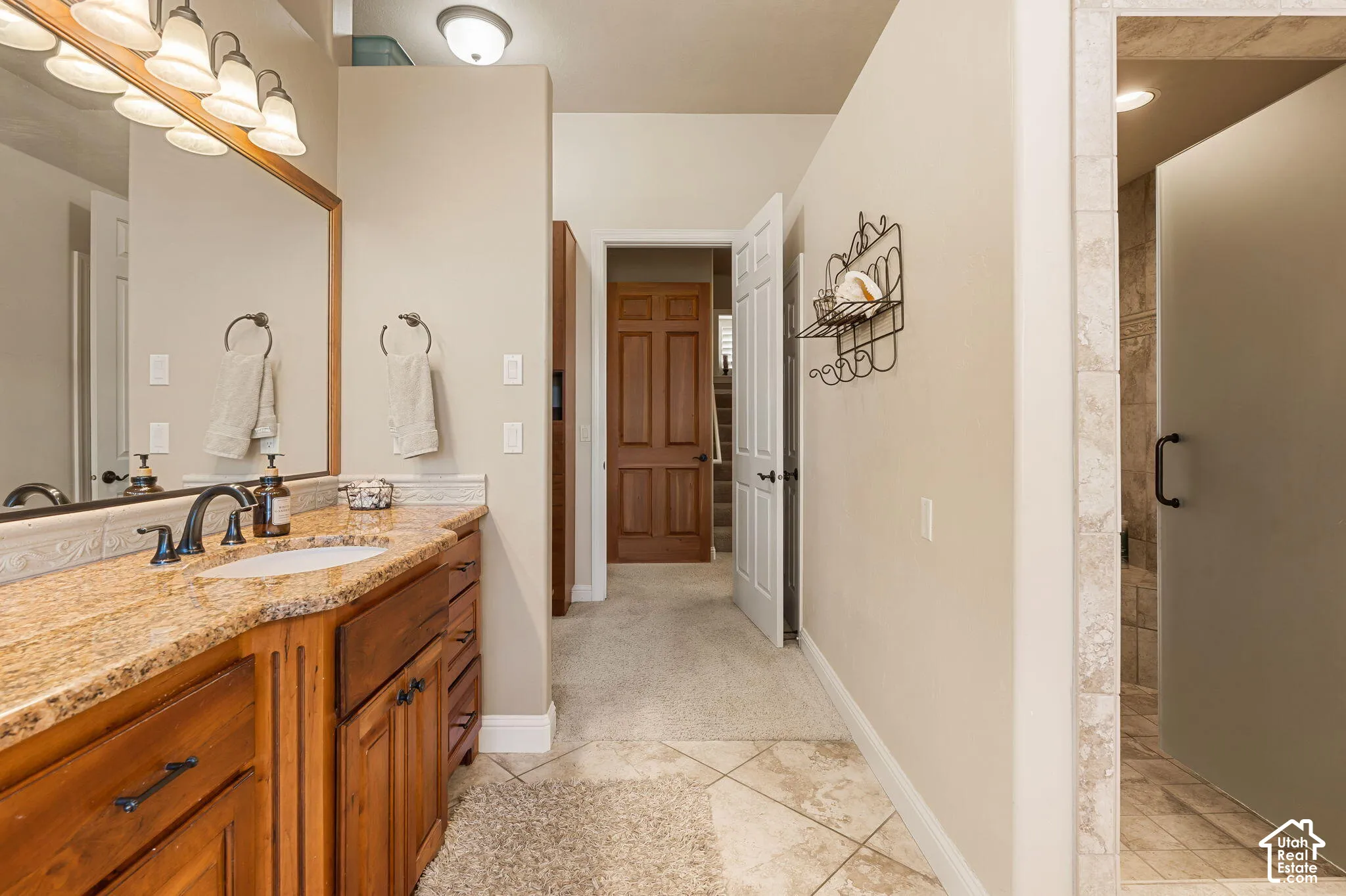 Warm wood-finish vanity with an undermount sink and stone countertop