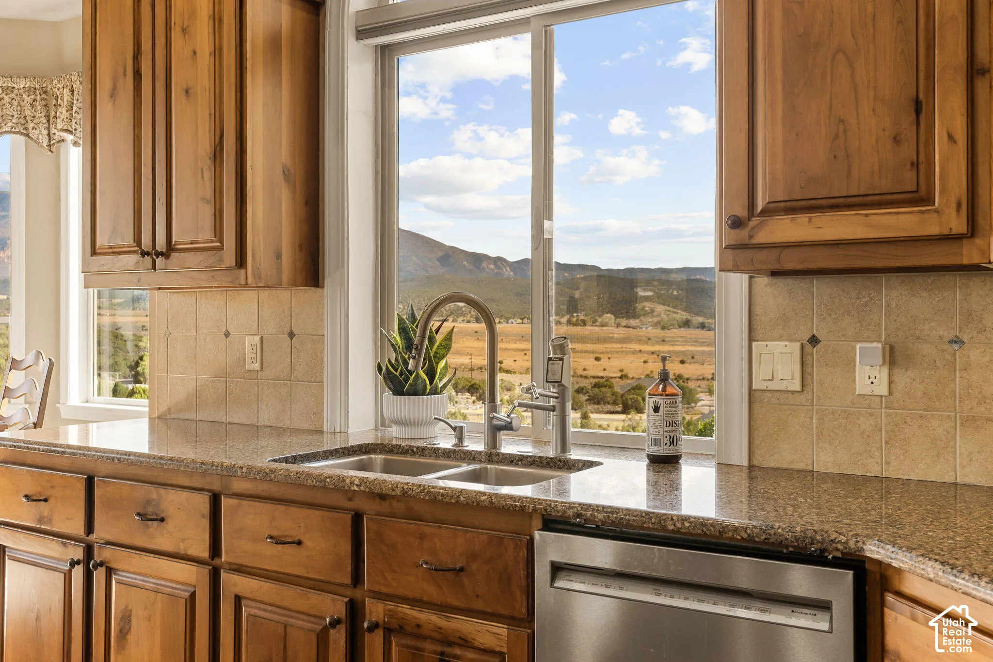 Natural wood cabinetry with dark hardware