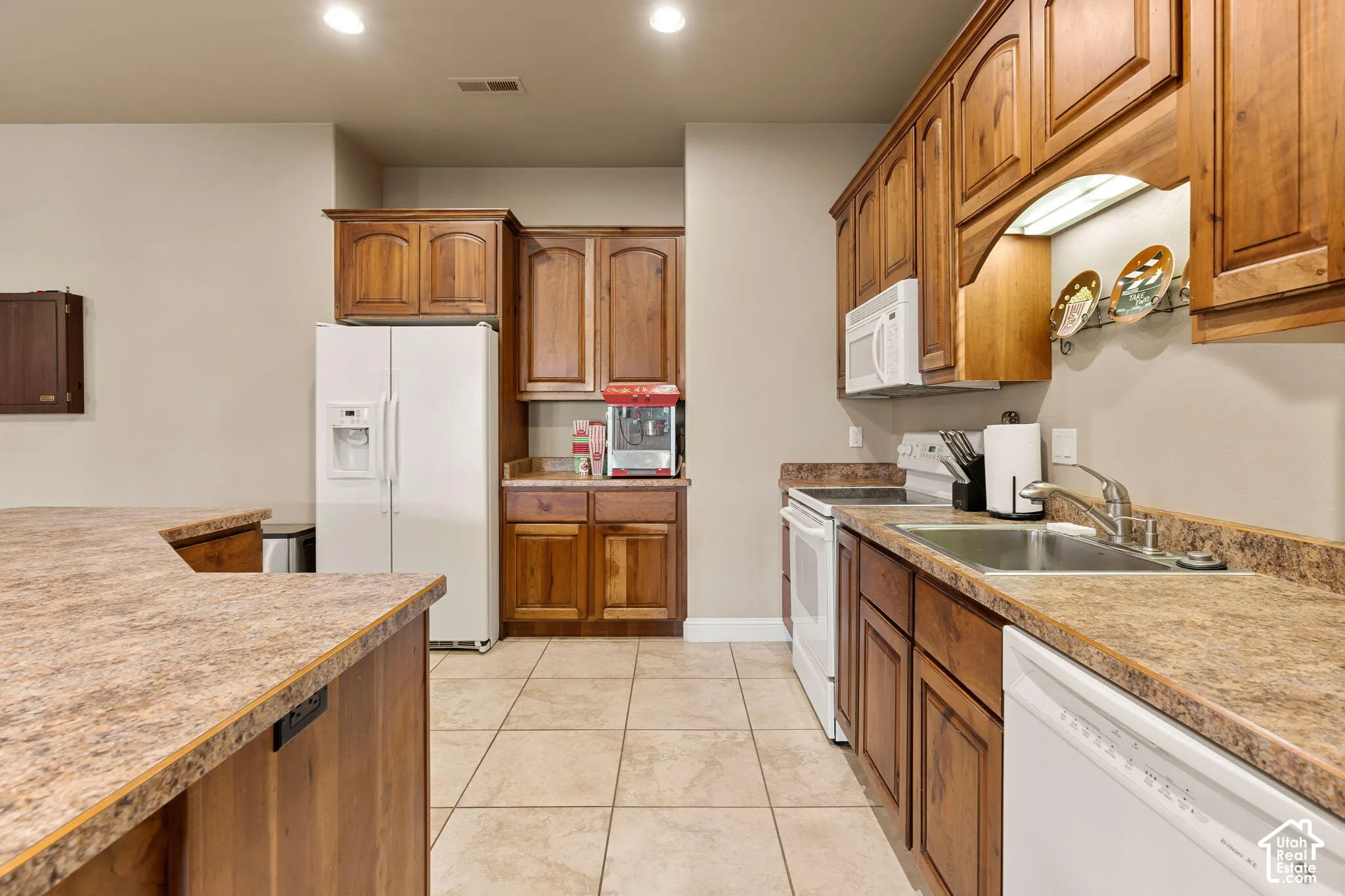 Wood-finish cabinetry paired with speckled countertops