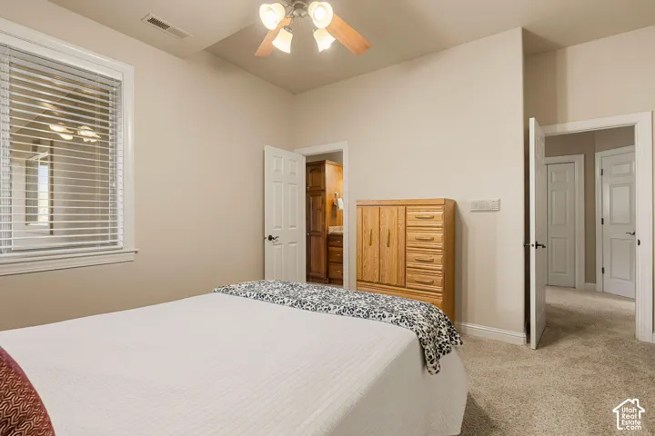 Ceiling fan fixture, white trim window, light neutral wall paint, white interior doors, and carpeted flooring