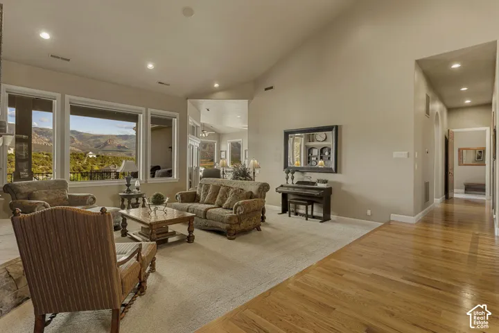 Recessed lighting, wood-finish flooring, vaulted ceilings, and large windows with mountain scenery