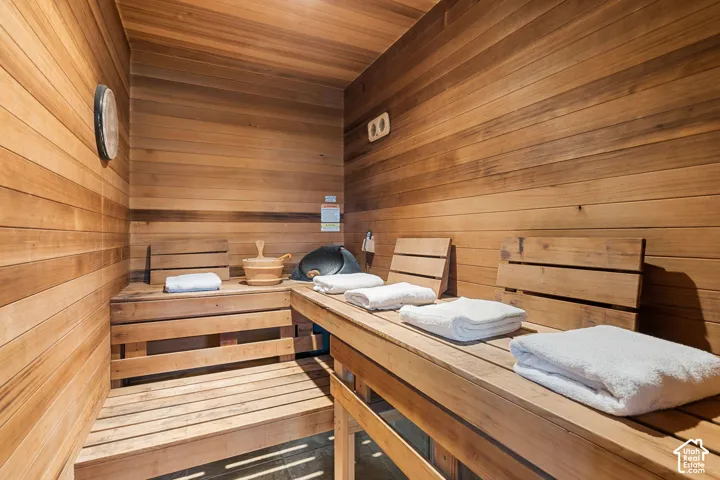 Wood-paneled interior featuring built-in wooden benches and slatted wood backrests