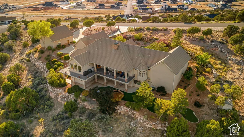 Two-story residence with a covered patio, multiple gables, and a detached structure