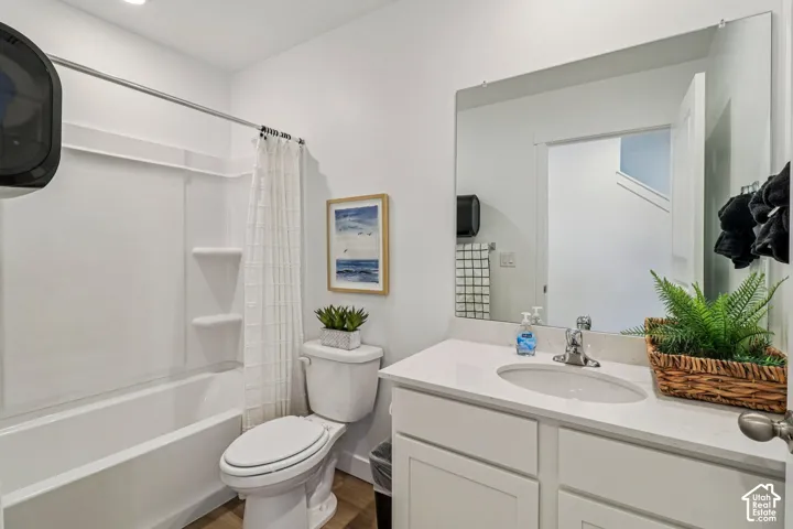 Vanity with a light-colored countertop, undermount sink, and chrome faucet