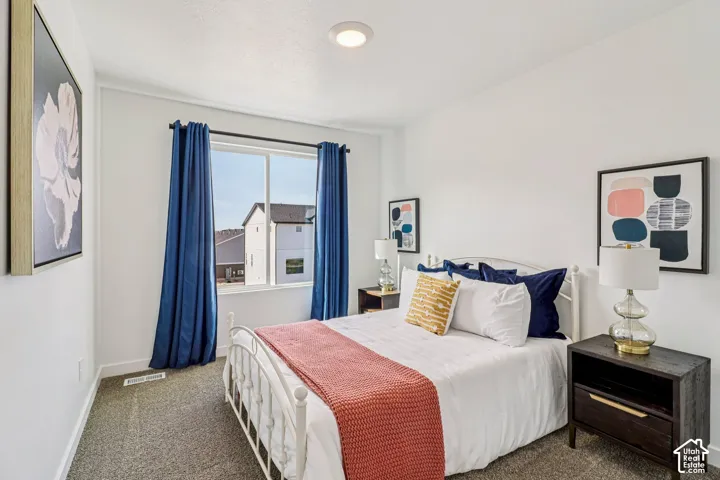 White walls with recessed lighting, carpet flooring, and a large window