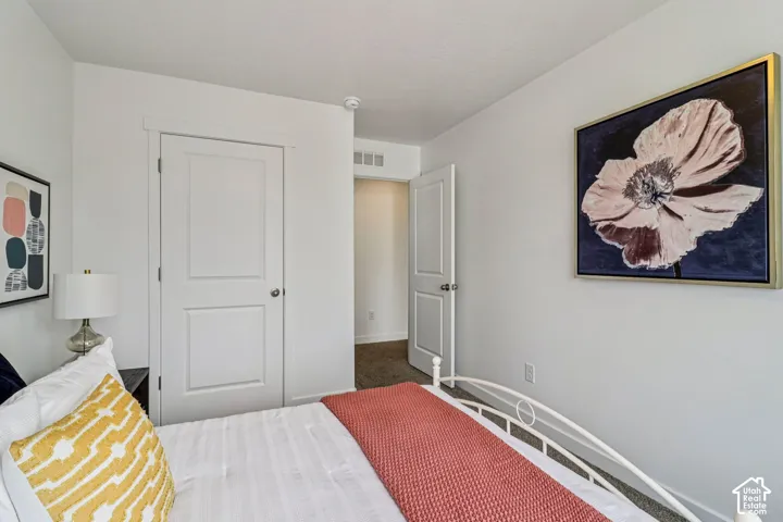 Light-colored walls with white trim, two white paneled doors, and carpeted flooring