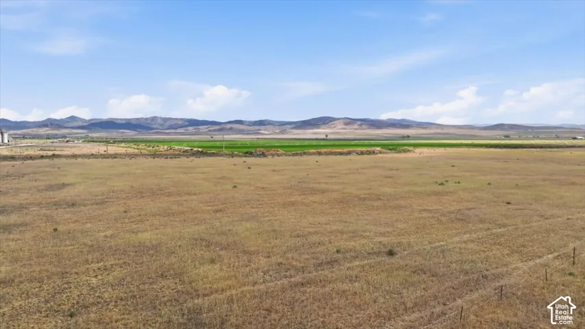 Expansive open land with distant mountains and clear skies