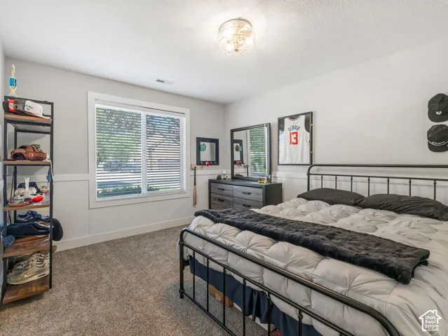 Neutral wall colors, textured carpeting, and wainscoting details create a refined aesthetic