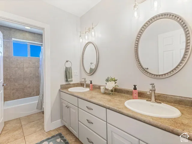 Dual vanity with a stone-finish countertop, undermount sinks, and brushed nickel fixtures