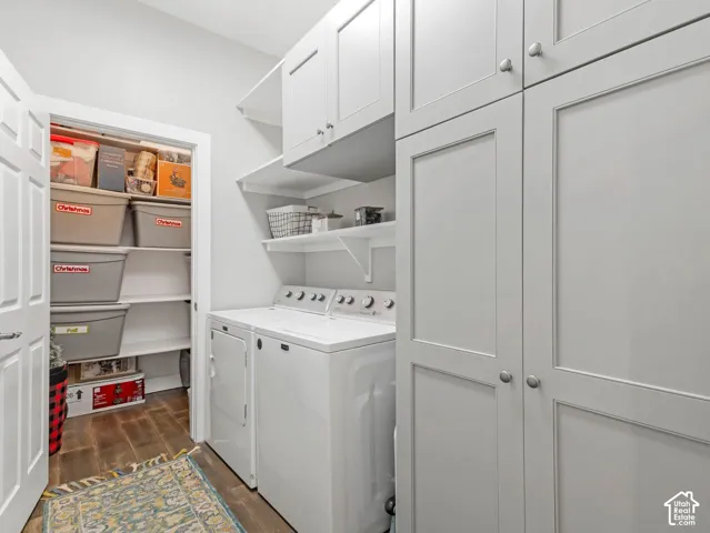 Laundry area featuring wood-finish flooring and extensive built-in cabinetry