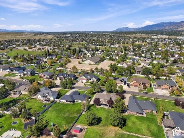 Expansive suburban setting featuring a mix of residential properties with mature trees and mountain scenery in the distance