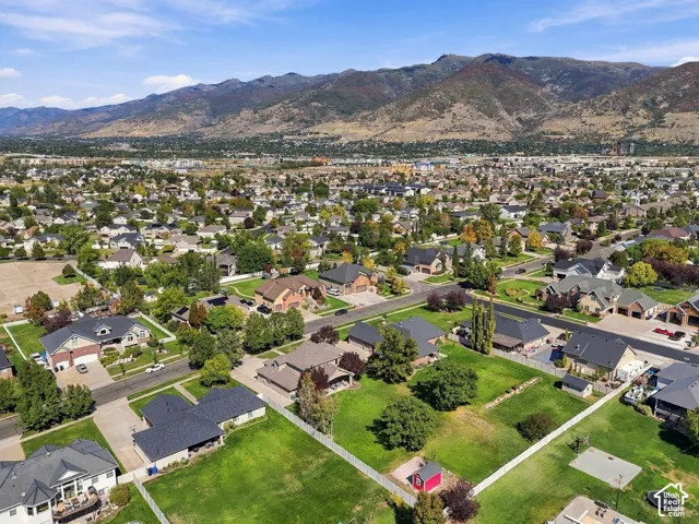 Residential neighborhood featuring single-family homes, mature landscaping, and mountain backdrop