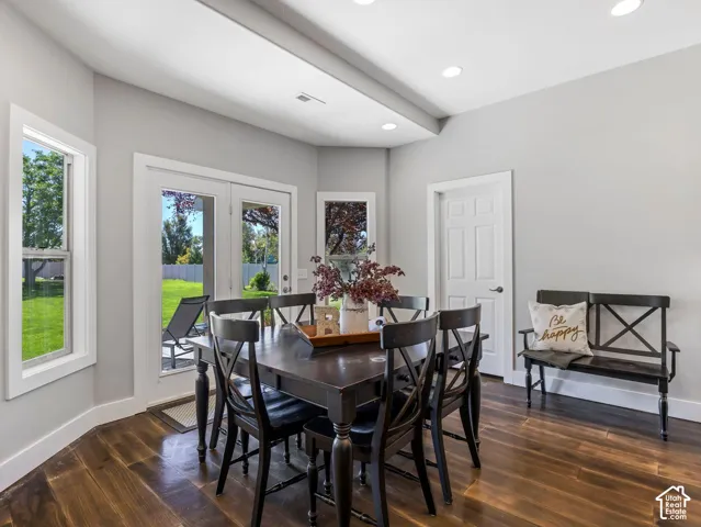 Wood-finish flooring, recessed lighting, and a white paneled door