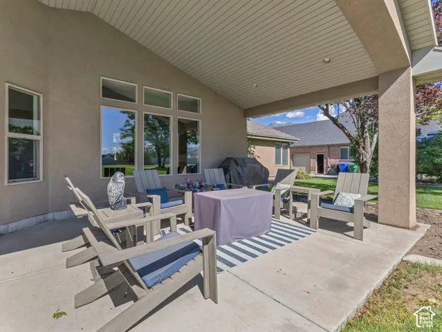 Covered patio featuring an angled ceiling and recessed lighting