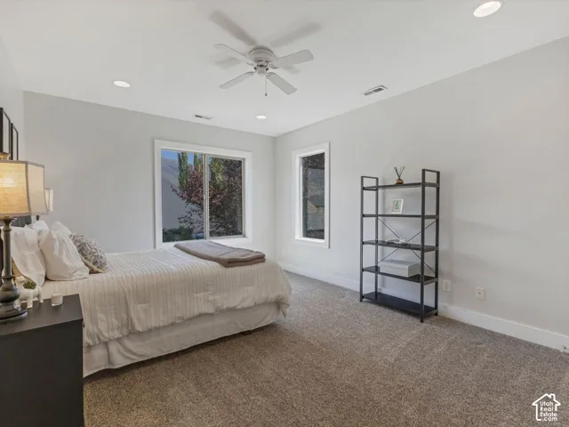 Recessed lighting, ceiling fan, carpeting, and multiple windows