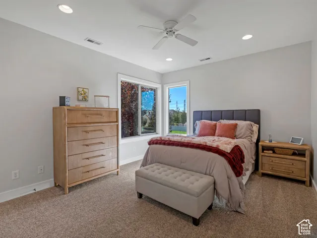 Recessed ceiling lighting, ceiling fan, corner windows, wall-to-wall carpeting, and light-toned wall finishes