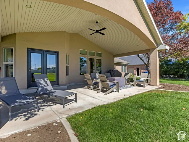 Covered patio with a concrete surface, featuring a ceiling fan, recessed lighting, and multiple windows