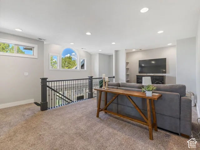 Carpeted upper level with recessed lighting