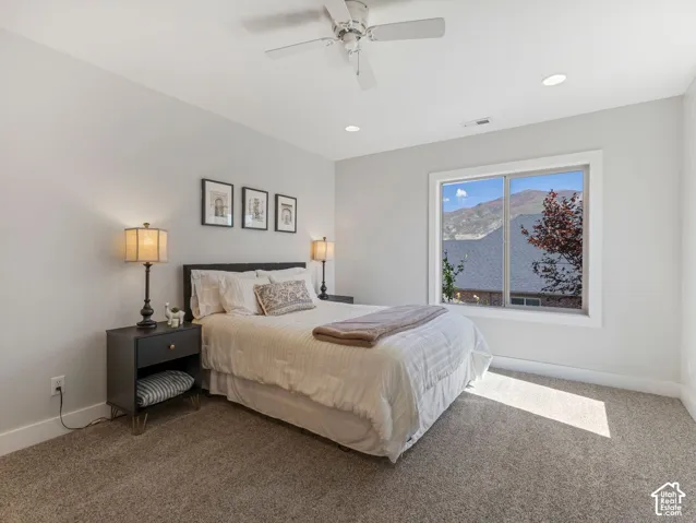Recessed lighting and a ceiling fan illuminate this space