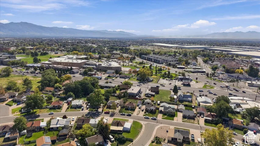 Expansive urban landscape with residential properties and mountain backdrop