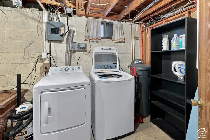 Laundry area featuring a top-load washer, front-load dryer, and open shelving