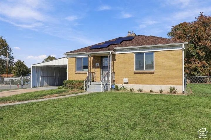 Lovely Clearfield home with solar panels, covered parking and large yard on corner lot.