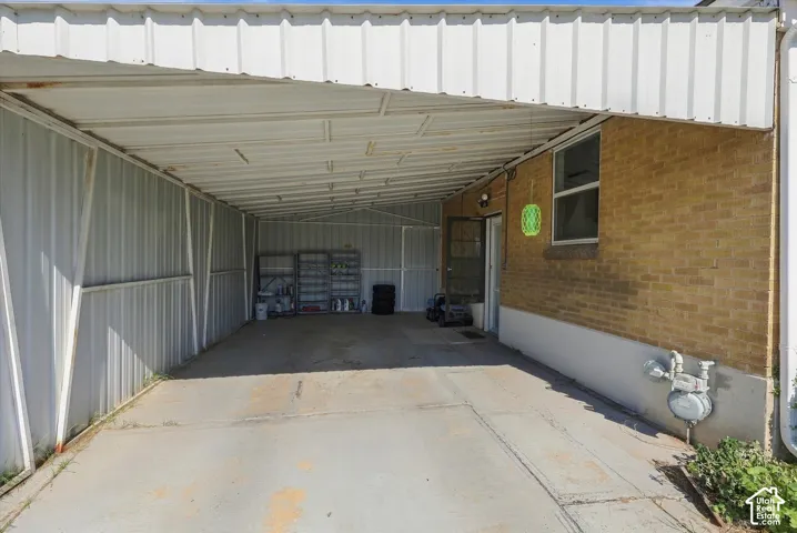 Carport with a metal roof and concrete flooring