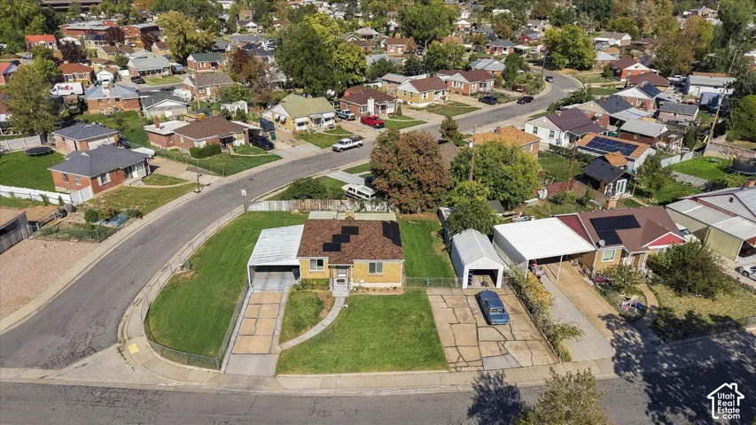 Property situated on a corner lot with a manicured lawn and mature trees