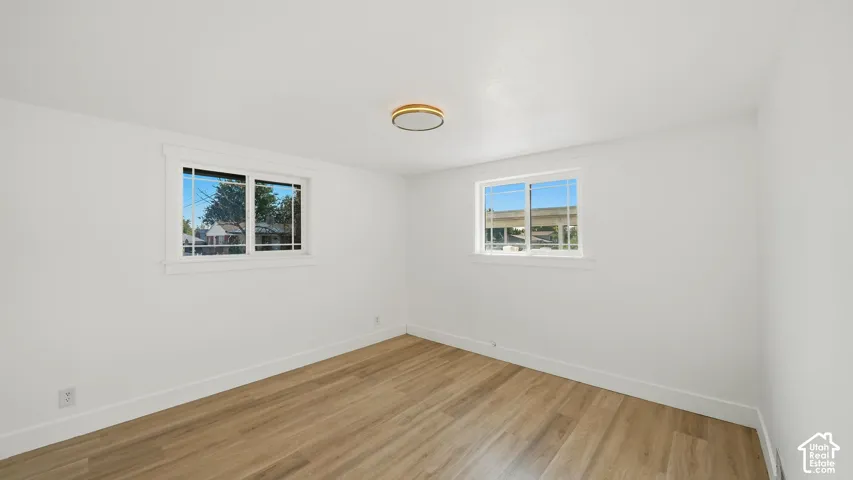Wood-finish flooring with white walls and trim