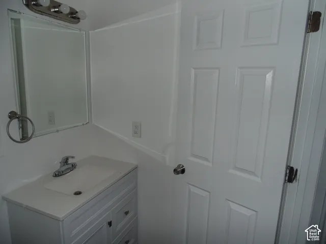 White vanity with an integrated sink and chrome faucet