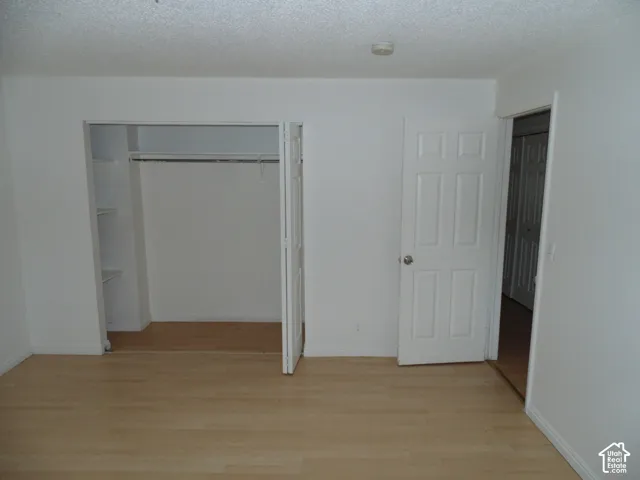 Light wood-finish flooring with white walls