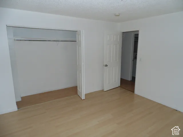 Light wood-finish flooring with white walls and trim