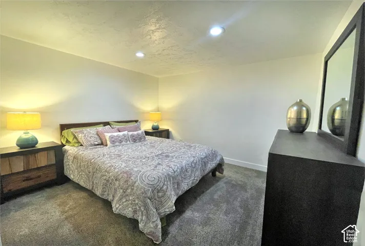 Recessed ceiling lighting, carpeted flooring, and light-toned walls