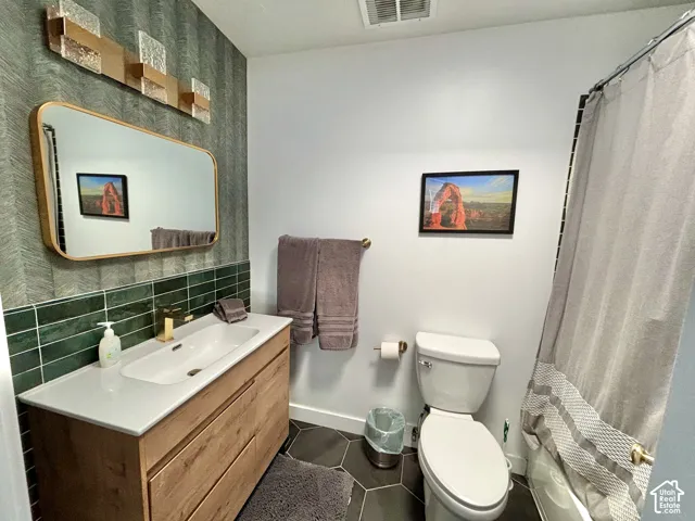 Floating vanity with integrated basin, gold-finish fixtures, and a rectangular framed mirror