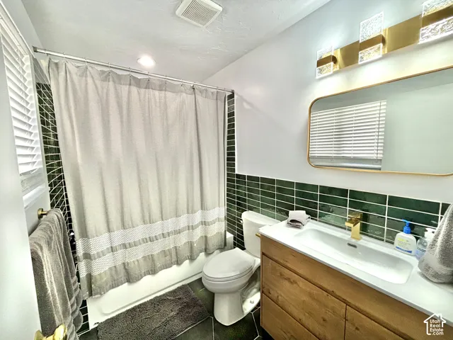 Modern vanity with integrated rectangular sink and gold-tone faucet, complemented by a gold-framed mirror