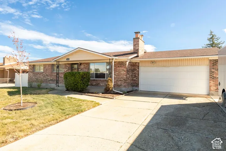 Brick exterior with a detached two-car garage and concrete driveway