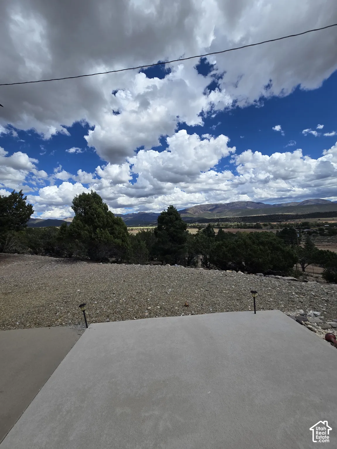 Concrete patio with two landscape lights and a gravel hardscape